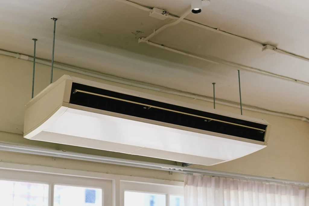 Suspended ceiling-mounted HVAC air handler or indoor unit.