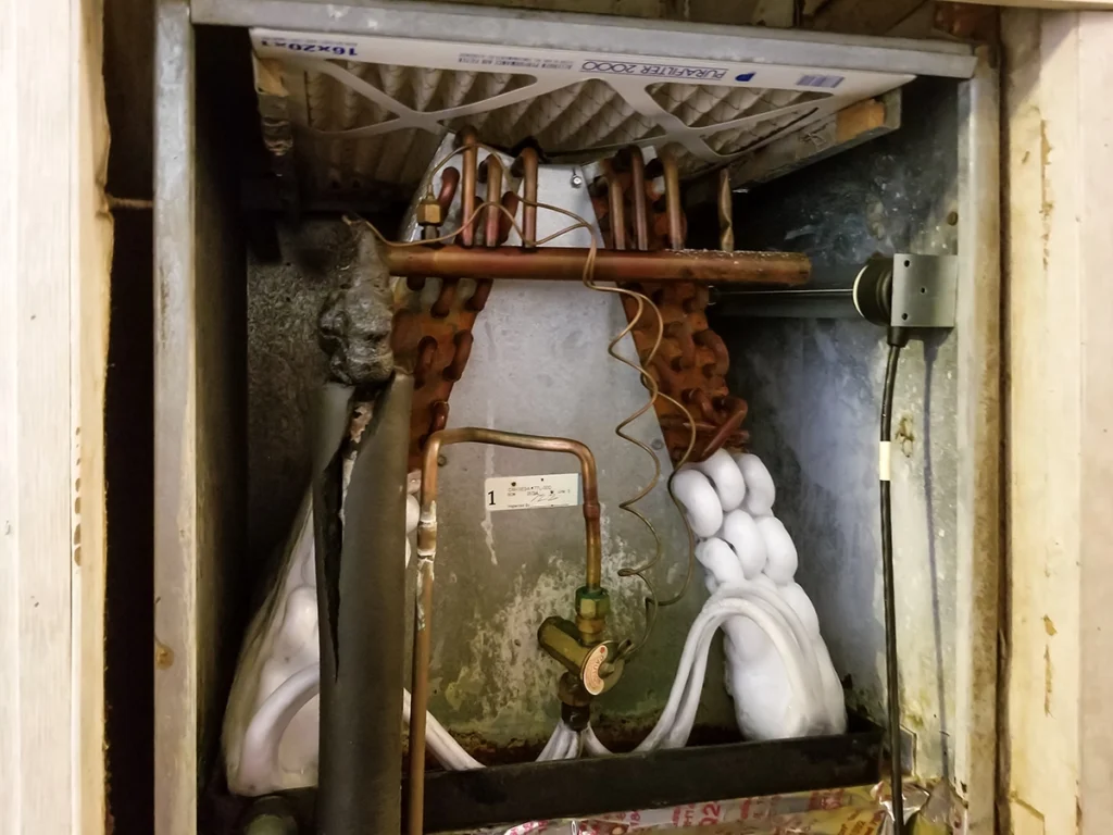 Air handler capacitor bulging and preventing fan from running in Lockport, LA: frozen indoor evaporator coil with visible