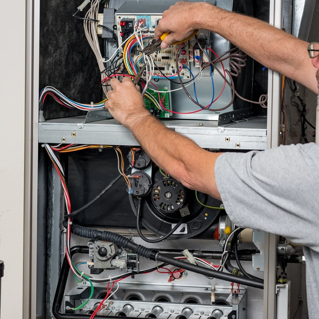 Furnace limit switch tripping and shutting off heat in Houma, LA: technician repairing wiring and electrical components